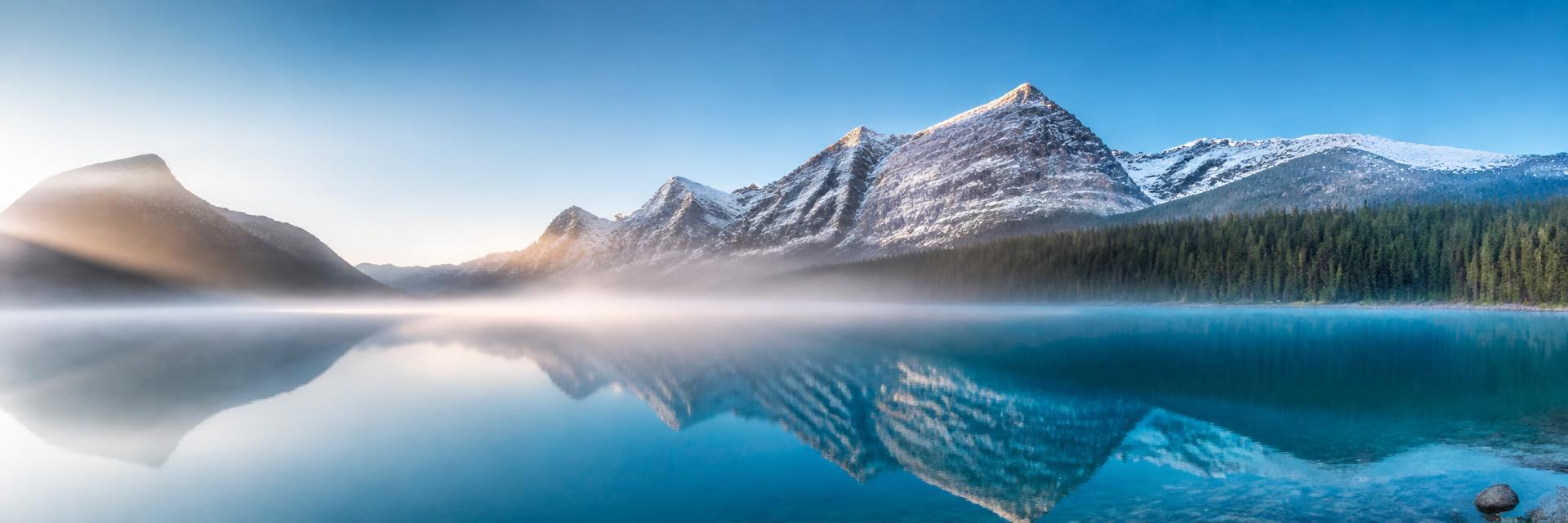 Calm mountain lake at sunrise